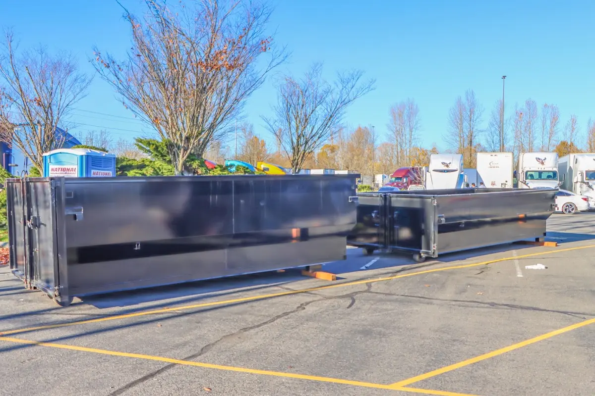 Professional dumpster rental service with roll-off container on residential driveway in Elk City